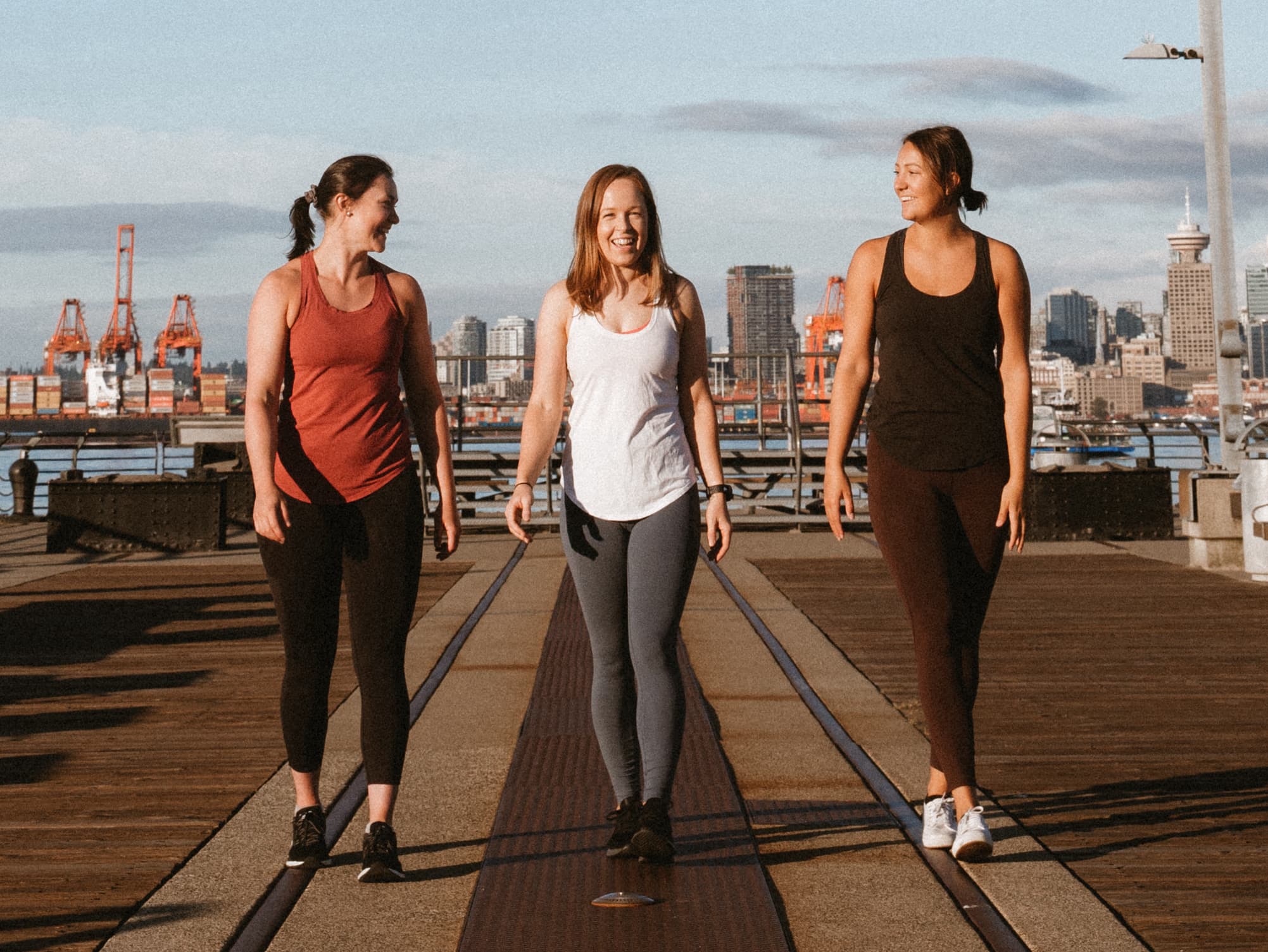 Briana, Andrea, and Jess walking along a dock