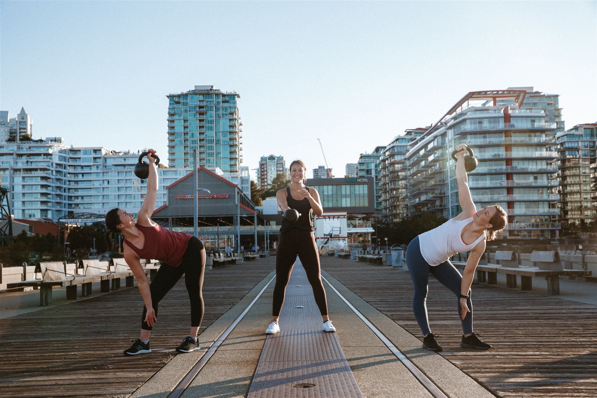 Briana, Jess, and Andrea doing exercises with kettlebells