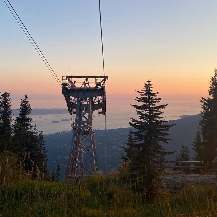 sunset over gondola tower on a mountain